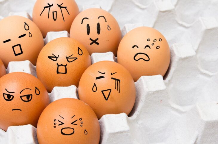 Eggs in carton with different emotions shown as drawing on their 'face'